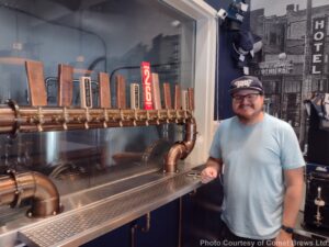 Owner of Comet Brews with new copper tap handle